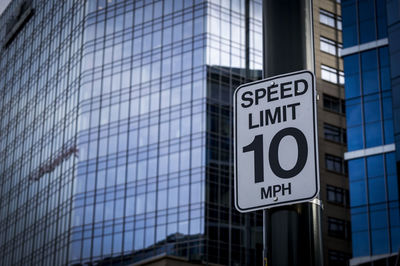 Low angle view of road sign against building