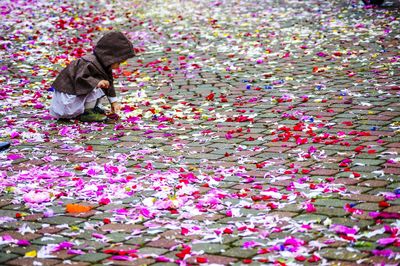 Child touching fallen streamers on ground