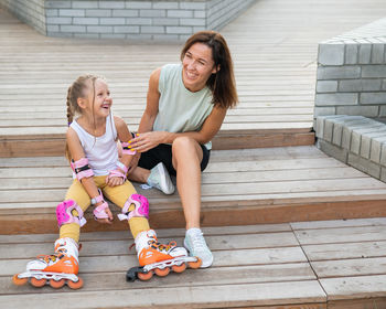 Portrait of siblings sitting on staircase