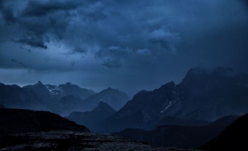 Scenic view of mountains against sky at dusk