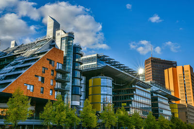 Low angle view of buildings against cloudy sky