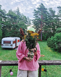 Rear view of woman holding bouquet