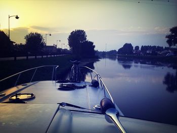 Boats in river at sunset