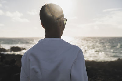 Young male tourist at los hervideros on sunny day, lanzarote, spain