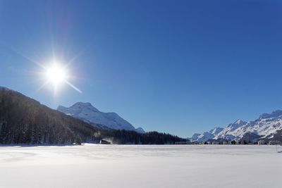 Scenic view of snowcapped mountains against clear sky