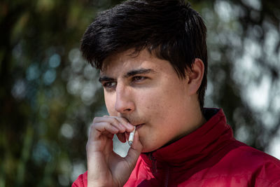 Young man looking away outdoors