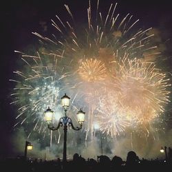 Low angle view of firework display at night