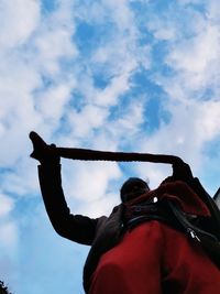 Rear view of man standing against sky