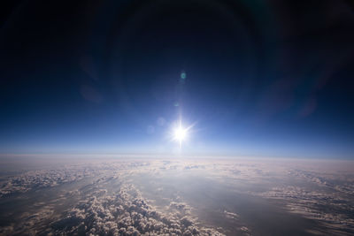 Aerial view of landscape against bright sun