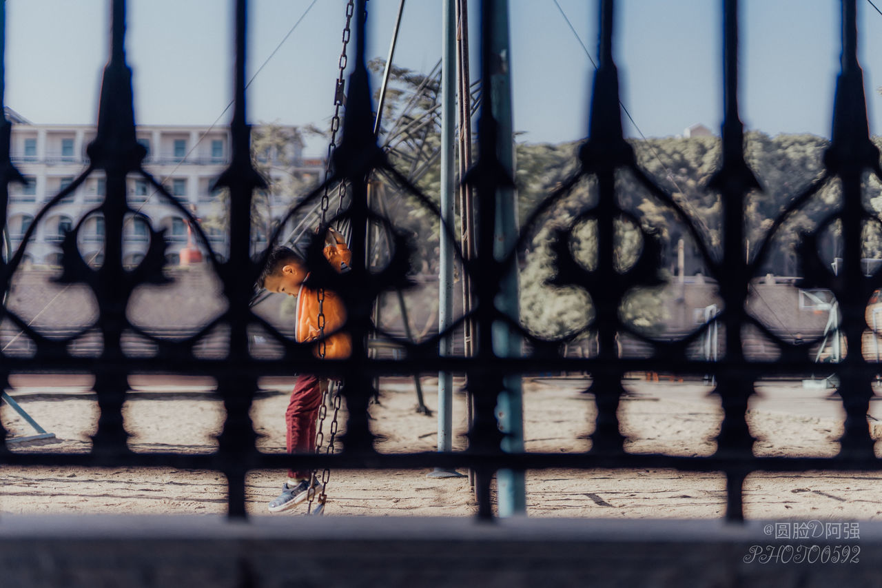 CHILDREN STANDING IN CITY