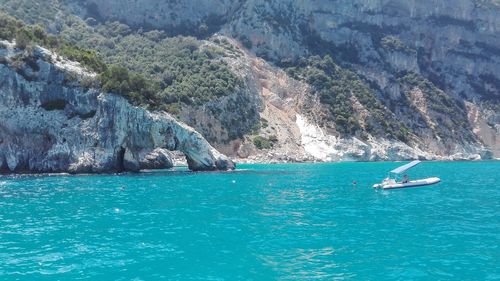 Scenic view of sea against rock formation