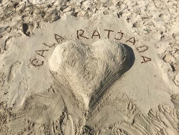 High angle view of text on sand at beach