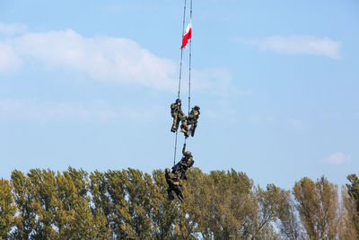 Low angle view of flags hanging against sky