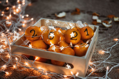 Christmas greeting  new year 2021 is coming, cozy christmas. black numbers 2021 written on oranges.