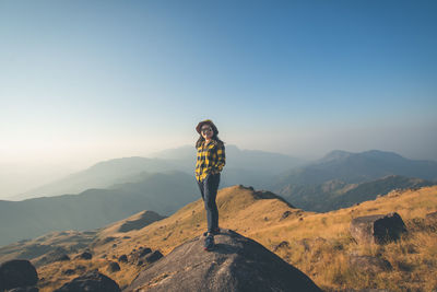Man standing on mountain against clear sky
