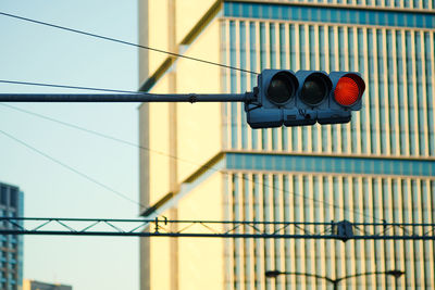 Low angle view of road signal against clear sky