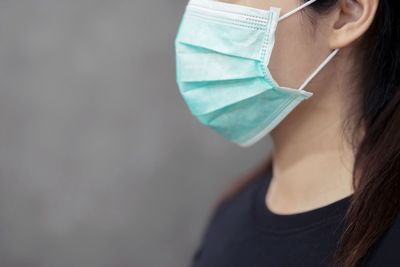 Side view of young woman with protective face mask