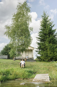 Senior couple relaxing in front of holiday home, kalvene, latvia