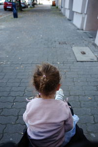 Rear view of woman on footpath