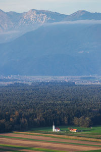 Scenic view of field and mountains against sky