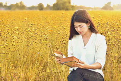 Beautiful young woman in field