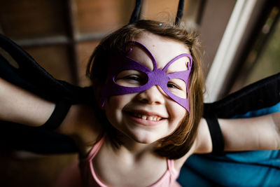 Close up of young girl in dress up smiling for camera