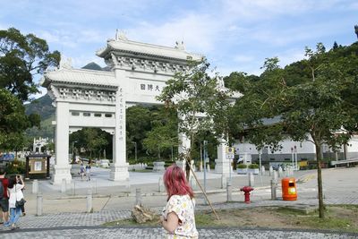 People in front of built structure against sky