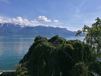 Scenic view of sea and mountains against sky