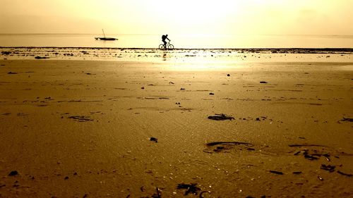 Scenic view of beach against sky during sunset