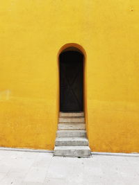 Minimalist doorway on a yellow building.