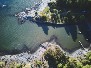High angle view of sea and trees in city