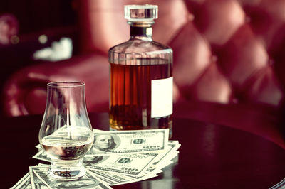 Close-up of glass bottle on table in restaurant