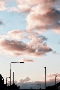 High section of street light against cloudy sky