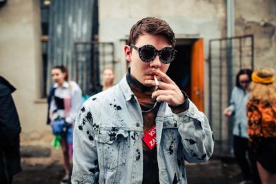 Young man wearing sunglasses standing outdoors