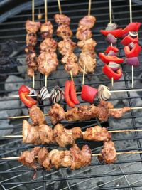 High angle view of meat in skewer on barbecue grill