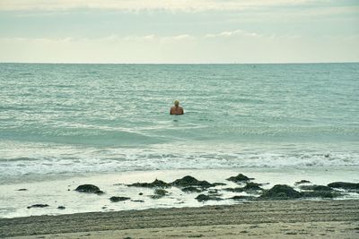 View of calm beach against the sky