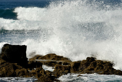 Sea waves splashing on rocks