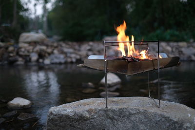 Bonfire on rock against water