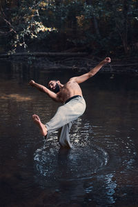 Full length of shirtless man in water