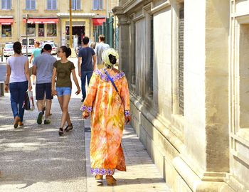 Rear view of people walking outdoors