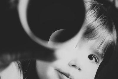 Close-up of cute toddler playing with cylindrical object