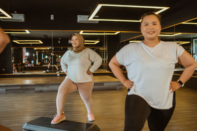 Portrait of young woman exercising in gym