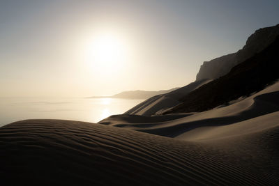 Scenic view of beach against sky during sunset