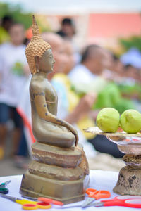 Close-up of buddha statue on table