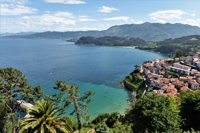 High angle view of sea and mountains against sky