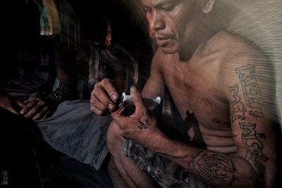 Close-up of man with tattoo on hand