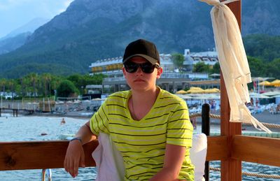 Portrait of man wearing sunglasses sitting outdoors