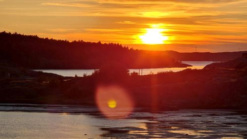 Scenic view of river against sky during sunset