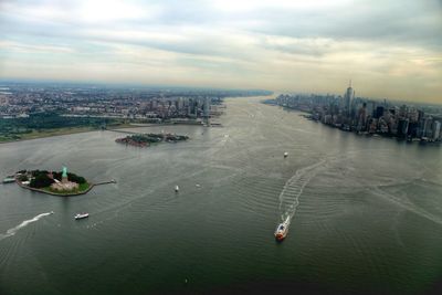 View of cityscape against cloudy sky