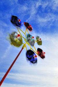 Low angle view of multi colored umbrellas against sky